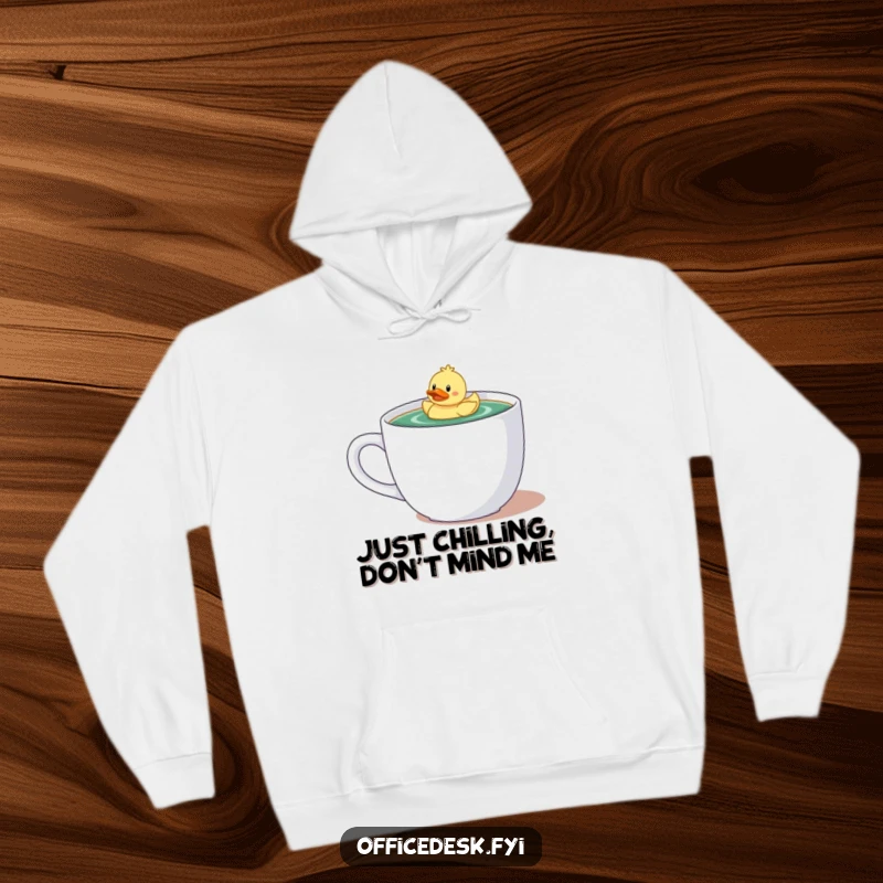 Funny hoodie with a tiny character and rubber ducky floating serenely in a large coffee mug, a cozy and humorous design.
